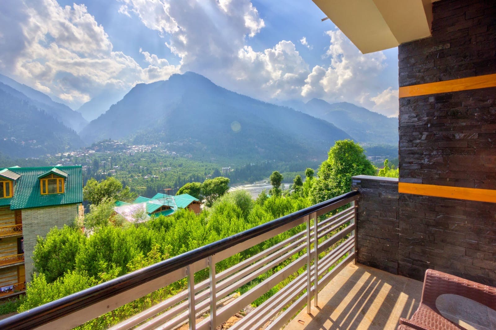 The home framed by deodar forest and snow peaks